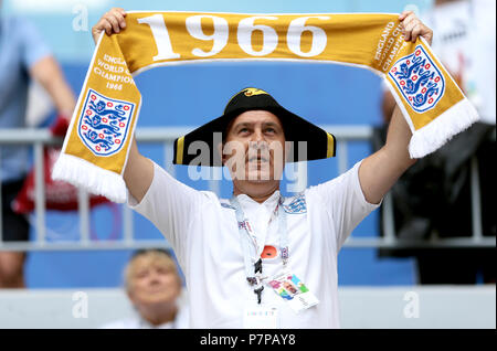 An England fan in the stands holds up a scarf celebrating England's 1966 World Cup win before the FIFA World Cup, Quarter Final match at the Samara Stadium. Stock Photo