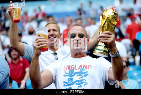 An England fan in the stands holds up a replica of the 2018 FIFA World Cup trophy before the FIFA World Cup, Quarter Final match at the Samara Stadium. Stock Photo