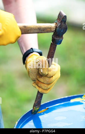 Closeup shot of chisel and hammer in hands of a worker Stock Photo