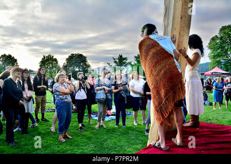 Aboriginal Carver, James Harry and Supporters presents his new totem to the audience. Shot from the stage's perspective at PCT, Port Moody, BC Canada Stock Photo