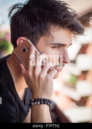 Young man outdoors talking on cell phone Stock Photo