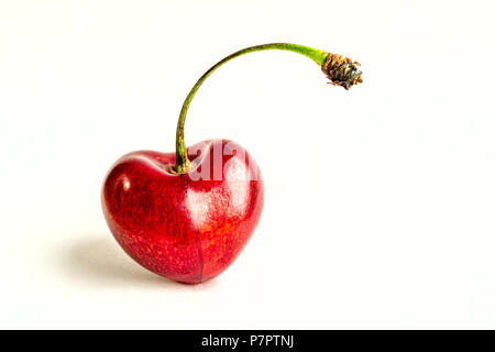 Berries of ripe cherries, drops of dew, a heart shape, one piece. Studio white background, valentine day Stock Photo