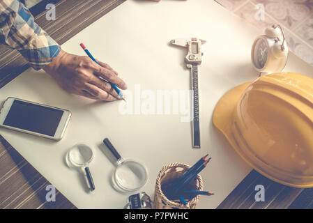 Engineer doing blank draft the drawing on white paper. Engineer and Structure concept. Construction theme Stock Photo