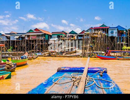 Picturesque Kampong Phluk floating village with multicolored boats and stilt houses, Tonle Sap lake, Siem Reap Province, Cambodia Stock Photo