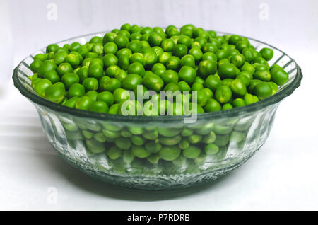 A glass bowl full of Green peas Stock Photo