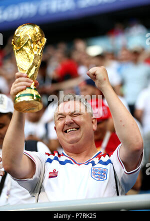 An England fan celebrates with a faux trophy after the FIFA World Cup, Quarter Final match at the Samara Stadium. Stock Photo