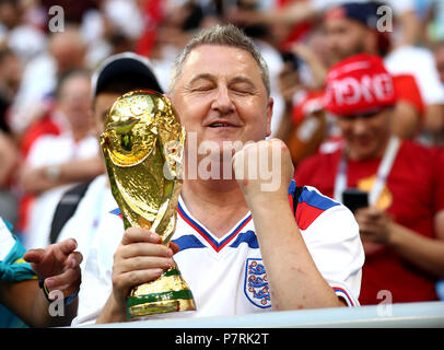 An England fan celebrates with a faux trophy after the FIFA World Cup, Quarter Final match at the Samara Stadium. Stock Photo