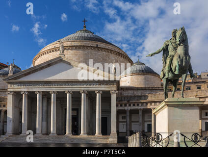 Bronze statue of King Ferdinand I of Bourbon and church San Francesco di Paola, Plebiscito Square ( Piazza del Plebiscito ) in Naples, Italy Stock Photo