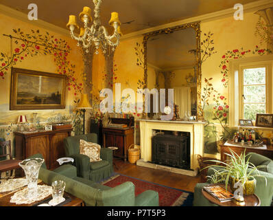 Antique furniture in old fashioned drawing room with decoratively painted walls Stock Photo