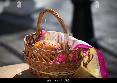 Easter cake in a basket with a candle Stock Photo