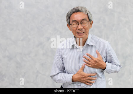 old man paint from heart attack hand cover chest with copy space Stock Photo
