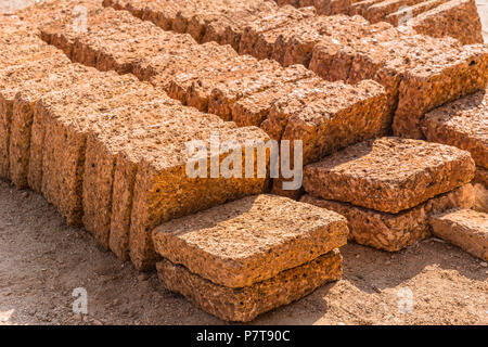 Laterite rock stone bricks plate from nature reddish rusty red color from rich in iron oxide Stock Photo