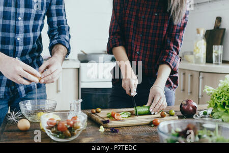 Couple preparing breakfast from vegetables at home in the kitchen Stock Photo