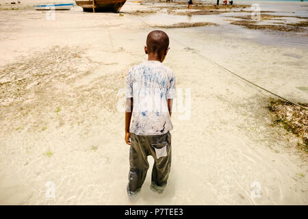 African child in search of seafood in the ocean Stock Photo