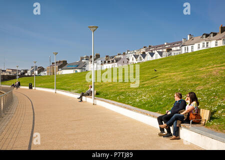 UK, Northern Ireland, Co Antrim, Portrush, promenade, vistors sitting in sunshine Stock Photo