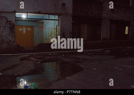 Condemned building window used as passage reflected on a puddle Stock ...