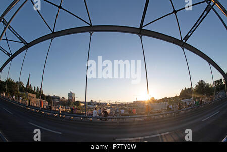 Berlin, Germany. 02nd July, 2018. People sit on the Modersohn Bridge to watch the sun set. Credit: Paul Zinken/dpa/Alamy Live News Stock Photo