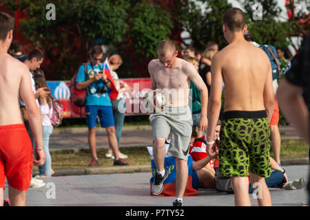 MOSCOW, RUSSIA - SATURDAY, JULY 7, 2018: Fan Fest Moscow, Vorobyovy Gory near Moscow State University. Fans watch FIFA games on large screens here. Cheerful mood, beautiful cityscapes. The area capacity is more than 30000 people. Football lovers from many countries meet here. People watch England vs Sweden game and are getting ready for Russia vs Croatia game. Unidentified people play very small football inside the Fun Fest area during the real game break. Credit: Alex's Pictures/Alamy Live News Stock Photo