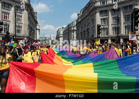 London, UK. 7th July, 2018. Flagbearers carry a rainbow flag during Pride in London parade. The annual festival attracts hundreds of thousands of people to the streets of the British capital to celebrate the LGBT+ community. Credit: Wiktor Szymanowicz/Alamy Live News Stock Photo