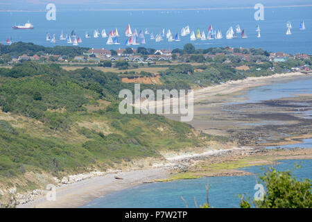 Culver Down, UK. 07th July, 2018. Yachts passing the eastern most point of the Island during the 'Round The Island Yacht Race' 2018. Photograph taken from Culver Down on the Isle of Wight overlooking Whitecliff Bay and Portsmouth as the yachts sail through the Solent Channel towards the finish line in Cowes. Credit: Matthew Blythe/Alamy Live News Stock Photo