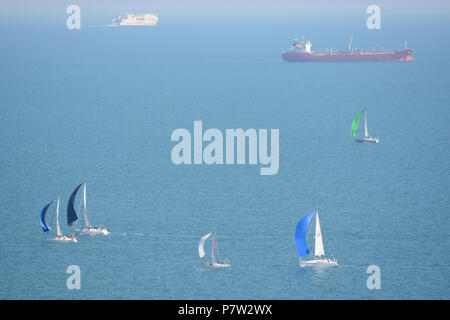 Culver Down, UK. 07th July, 2018. Yachts passing the eastern most point of the Island during the 'Round The Island Yacht Race' 2018. Photograph taken from Culver Down on the Isle of Wight overlooking Whitecliff Bay and Portsmouth as the yachts sail through the Solent Channel towards the finish line in Cowes. Credit: Matthew Blythe/Alamy Live News Stock Photo