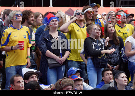 St. Petersburg, Russia - July 7, 2018: Swedish football fans at FIFA Fan Fest in Saint Petersburg watch the quarterfinal match of FIFA World Cup 2018  Stock Photo