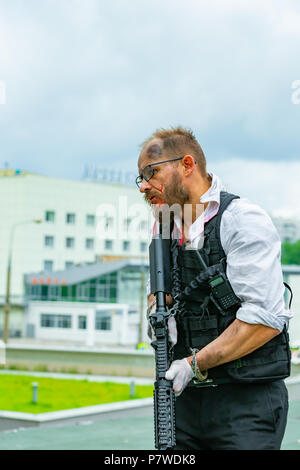 man dressed in a bulletproof vest, a shirt in his blood, pursues a victim with a gun Stock Photo - Alamy man dressed in a bulletproof vest, a shirt in his blood, pursues a victim with a gun Stock Photo - Alamy
