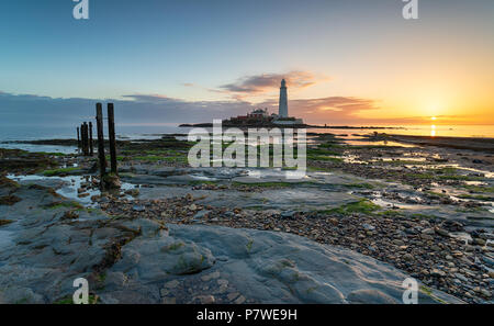 Beautiful sunrise over St Mary's Island and it's lighthouse at Whitley Bay in Tyne and Wear Stock Photo