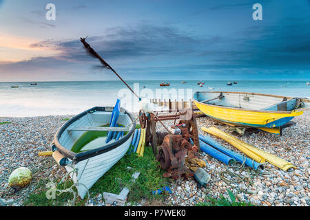Dramatic sunrise over boats on the beach at Selsey Bill on the Sussex coastline Stock Photo