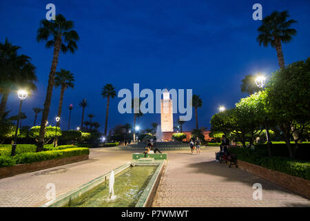 Marrakesh, Morocco - November 08, 2017: View of the Koutoubia Mosque during the blue hour in Marrakesh with palm trees in the foreground Stock Photo