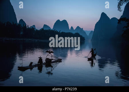 Cormorant fishermen pre-dawn in a quiet time before starting to fish, Li River, China Stock Photo