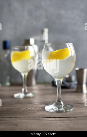 Vesper Martini Cocktail with lemon wedge. Homemade Vesper Cocktail on table, copy space. Stock Photo