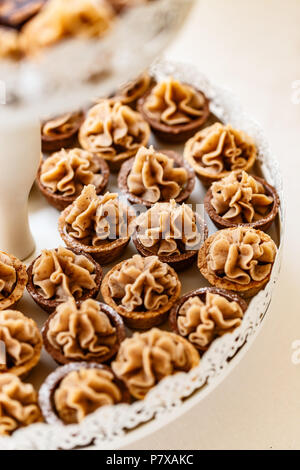 Delicious mini tarts (tartlets) with walnut whipped cream Stock Photo