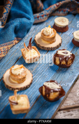 Different kinds of beautiful pastry, small sweet cakes Stock Photo