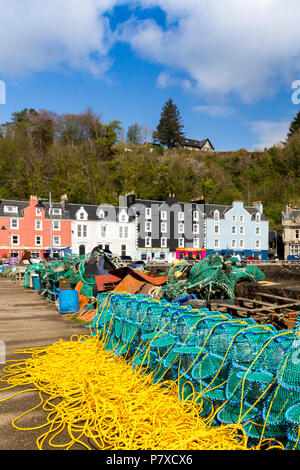 A stack of colourful new lobster creels on the harbour wall in Tobermory, Isle of Mull, Argyll and Bute, Scotland, UK Stock Photo