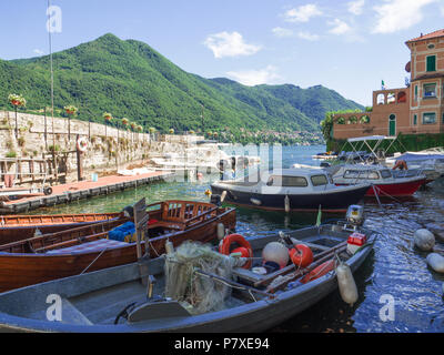 fishing boat loaded with fishing gear in a small dock of the Como lake,Italy Stock Photo