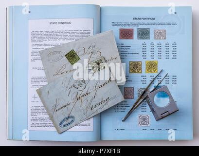 1852 Papal States (Italy) stamps and Sassone specialised catalogue handbook. Stock Photo