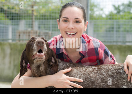 shelter keeper loves her residents Stock Photo