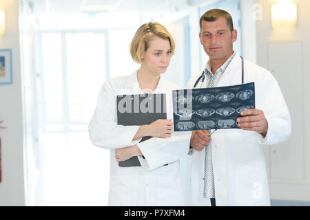 two medical technicians looking at mri x-ray of patient Stock Photo