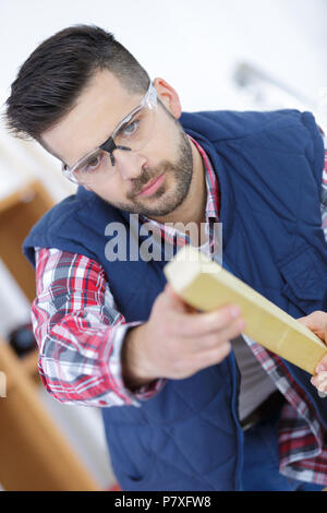 young handsome carpenter working in his workshop Stock Photo