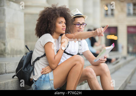 couple of tourists looking at city guide Stock Photo