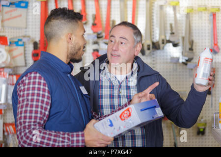 male seller advising client in hardware store Stock Photo