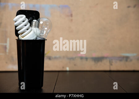 Old burnt fluorescent energy saving lamps. Stock Photo