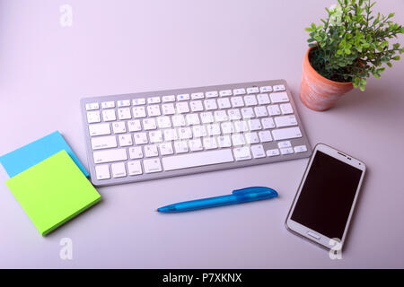 Office desk with keyboard and stikers, papers Stock Photo