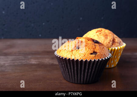 Tasty chocolate cupcakes, muffins on a white wooden table Stock Photo