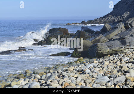 Pacific Ocean wave splashes against rock on coast Baja, Mexico Stock Photo