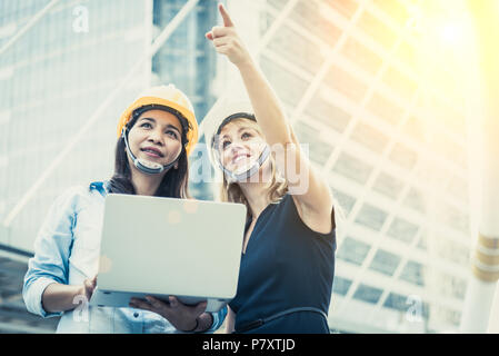 Two women engineering surveying for startup and launching new project. Building and construction concept. Business and happiness of cooperation concep Stock Photo