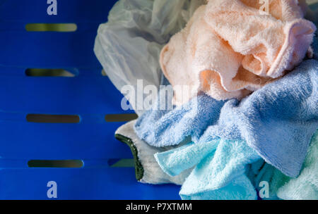Unused fabric and plastic bag from manufacturing industry on blue plastic chair background. Pollution and Junk concept. Recycle and Reuse theme. Stock Photo