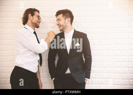 Two young smart businessmen talking together during leisure time at indoor. Business teamwork and coworker concept, Relax concept. Soft tone pinterest Stock Photo