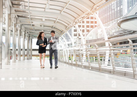 Businessman watching the watch and and his secretary are hustling in rush hour, Business concept Stock Photo